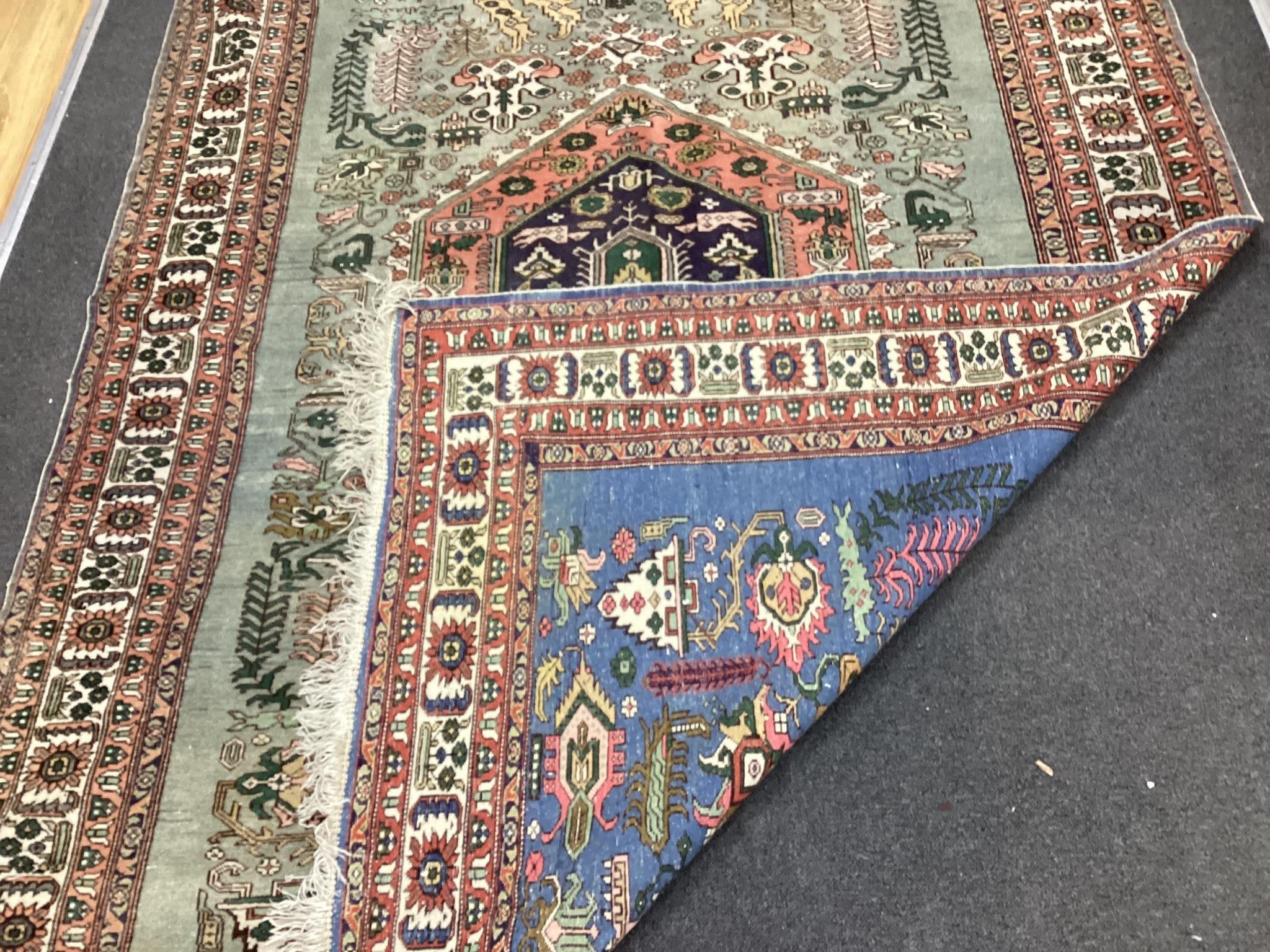 A Turkish faded blue ground carpet, 264cm x 170cm